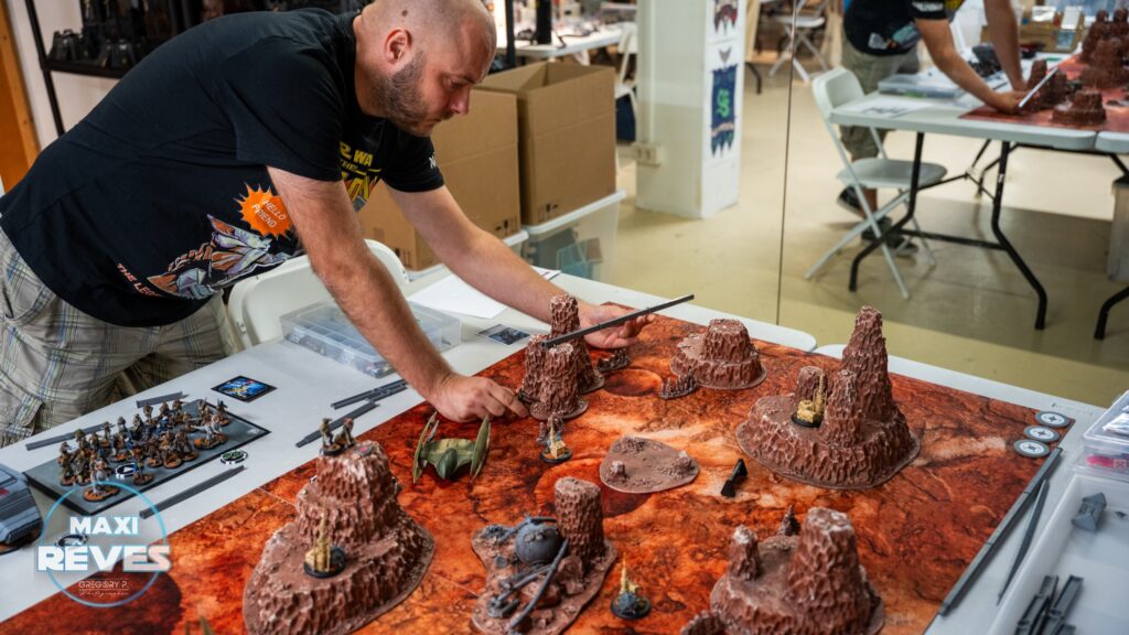 Préparation d'une table désert au tournoi Star Wars Legion de Maxirêves, armée rebelle rangée en bord de table